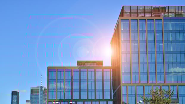 Glass building with transparent facade of the building and blue sky. Structural glass wall reflecting blue sky. photo