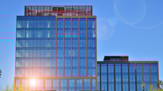 Glass building with transparent facade of the building and blue sky. Structural glass wall reflecting blue sky. photo