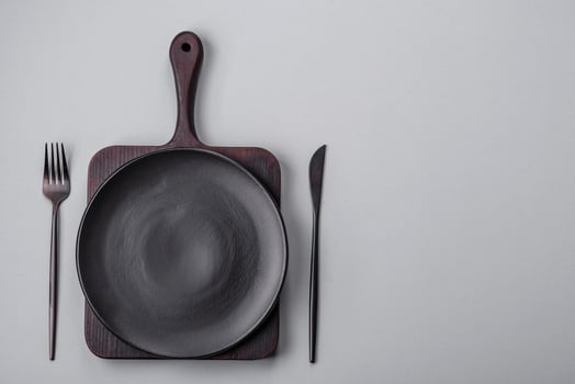 An empty plate on a gray concrete background with copy space photo