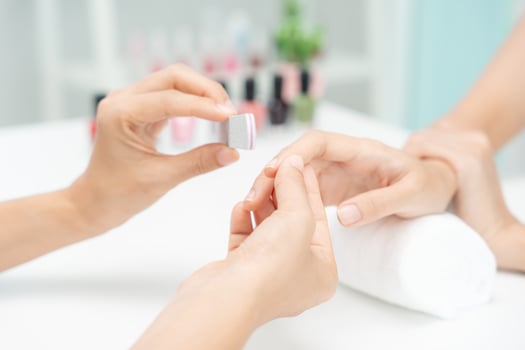 Woman receive care service by professional Beautician Manicure at spa centre. Nail beauty salon use nail file for Glazing treatment. manicurist make nail customer to beautiful. body care spa treatment photo