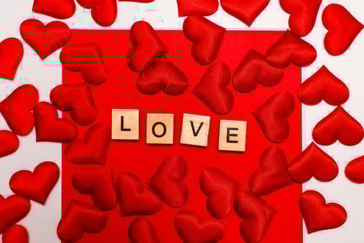 Top view of the inscription with the word love on a red background. Love concept, valentine's day. photo