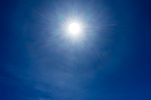 Sun rays on blue sky with bottom space. photo
