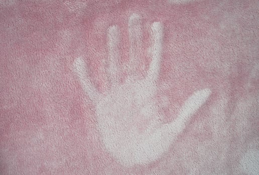 The footprint of a people hand on the surface of the fabric. Copy space. Selective focus. photo