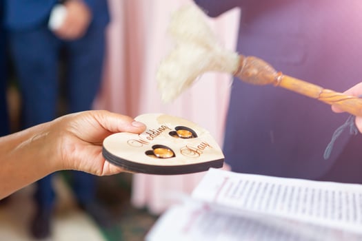 the priest sanctifies the wedding rings of the newlyweds in the church photo