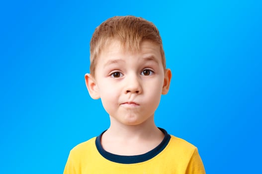 portrait of a little boy with the emotion of misunderstanding, surprise thoughts photo