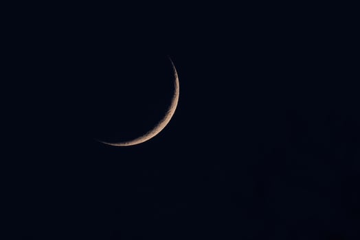 A thin sliver of the crescent moon photo