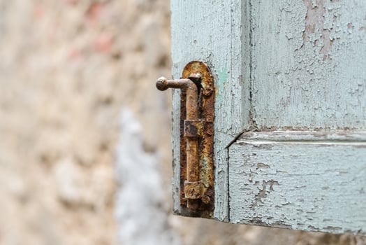 Rust locked bolt with old wooden window photo