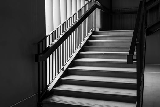 Empty Modern Concrete Staircase and black steel handrail with natural light, staircase in modern building - Dark Tone photo