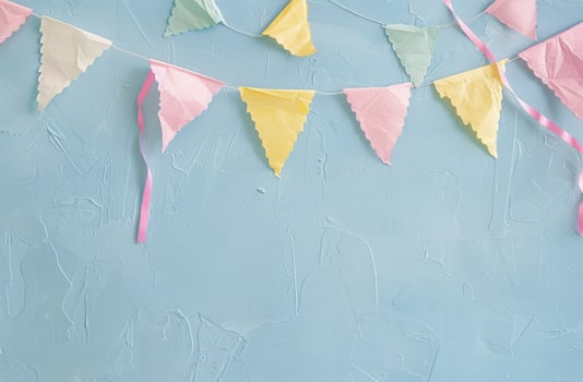 Vibrant Blue Wall With Pink, Yellow, and Green Paper Pennants photo