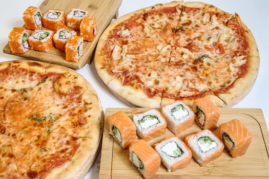 Table Adorned With a Variety of Pizzas and Sushi Rolls. photo