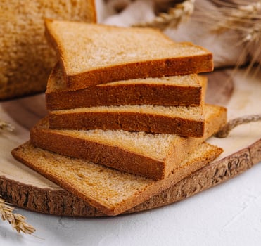 Pieces of white bread loaf for toast on a wooden board photo