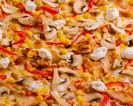 pizza with bell peppers, corn, meat and mushrooms close up photo