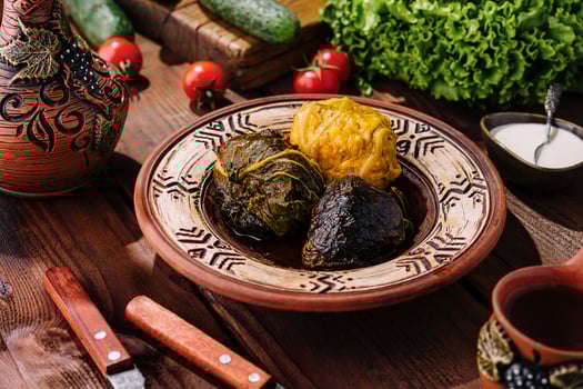 Traditional stuffed grape leaves on ceramic plate photo