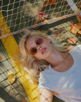 Woman Laying in Hammock Surrounded by Leaves photo