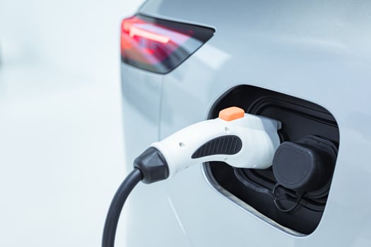 EV Car or Electric car at charging station with the power cable supply plugged. EV charging station for electric car in concept of green energy and eco power produced. photo