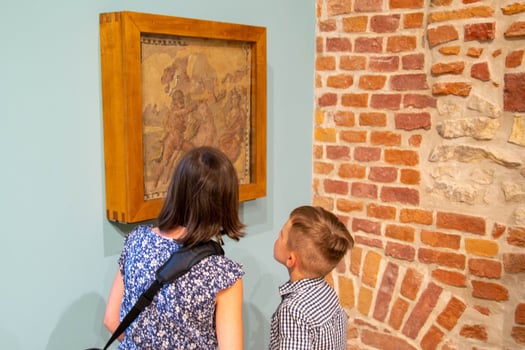 Young boy observing with interest sculptures photo