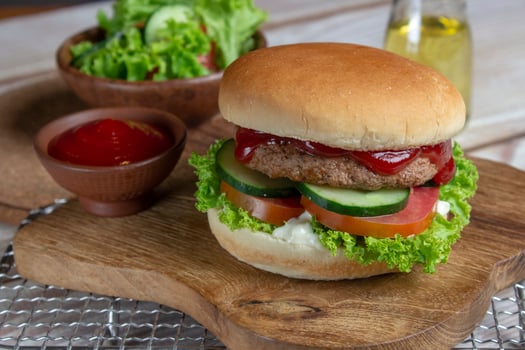 Delicious fresh meat burger with tomato sauce. photo