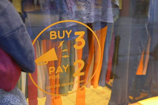 Large Sale text letters on red background on clothing store . photo