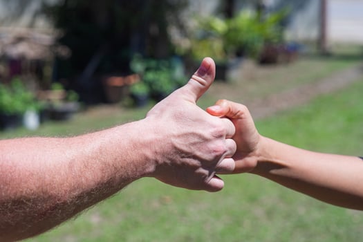 Close-up of two hands showing signals of success and good photo