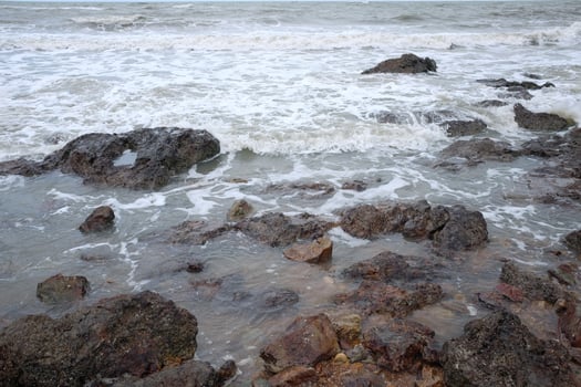 Beautiful landscape of Rocky coastline and blue sea with cloud storm on the sky in Thailand.Seascape concept photo