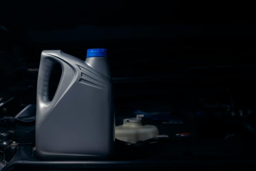 lubricant bottle On the background of engine lubricant, oil change shop, engine service industry. photo
