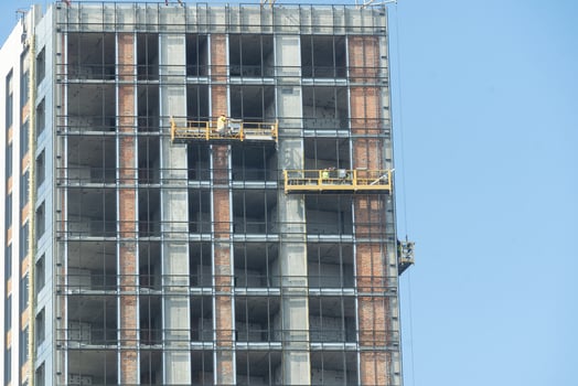 construction of modern multi-storey buildings. workers in the construction cradle photo
