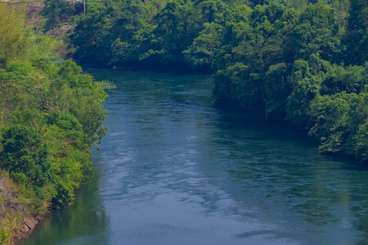 An aerial view of the dam-caused canal in Thailand's national park, with a mountain the background. Bird eye view. photo
