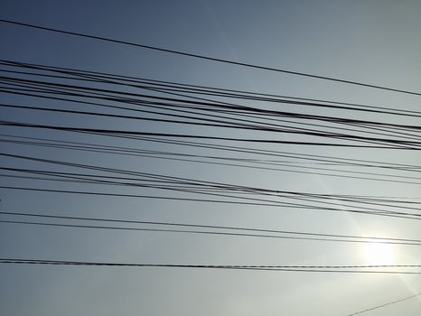 low angle view of cables against blue sky photo