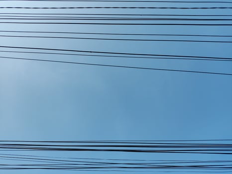 low angle view of cables against blue sky photo