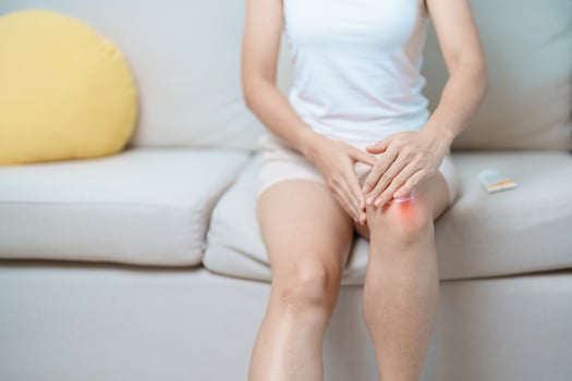 Arthritis and Muscle Pain Relief Cream concept. woman having knee ache and muscle pain due to Runners Knee or Patellofemoral Pain Syndrome, osteoarthritis, rheumatism and Patellar Tendinitis photo