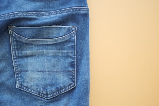 man jeans on a bright yellow background with copy space. photo