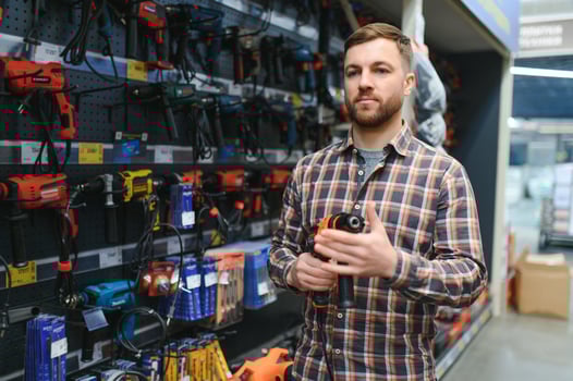 handsome young man shopping for tools at hardware store photo
