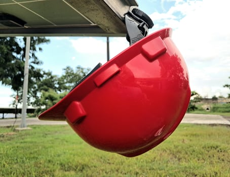 Plastic safety helmet isolated on panel surya background photo