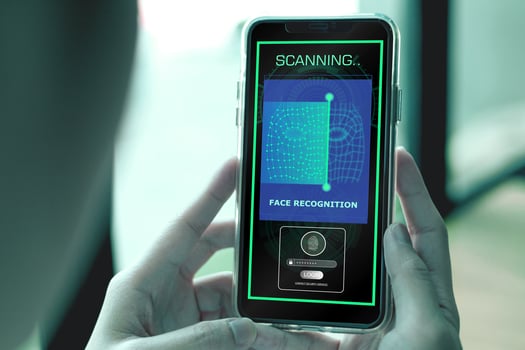 Security system with facial recognition, Face ID. Woman unlocks smartphone with biometric identification scan, personal verification photo