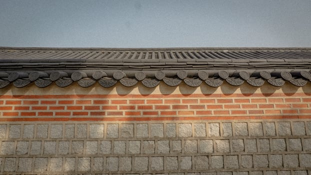 Traditional Korean Roof Design Against a Clear Sky at Dusk photo