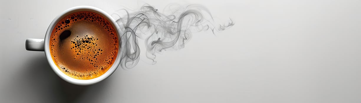 A cup of coffee with smoke rising from it on a white background. photo
