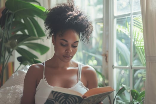 young woman reading a book at home. photo