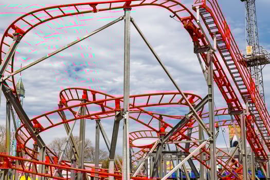 a part of a looping roller coaster in an amusement park photo