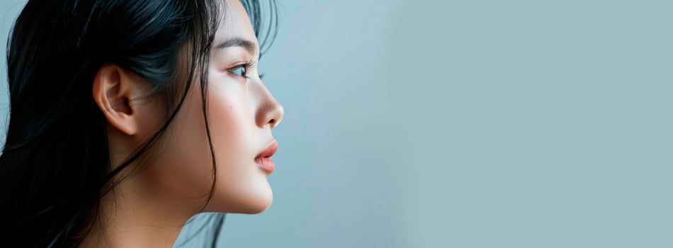 a close up of a woman s face with a gray background photo