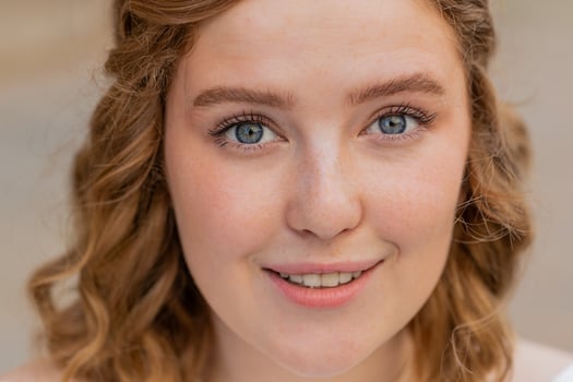 Close-up portrait natural beauty young beautiful redhead woman girl face smiling looking at camera photo