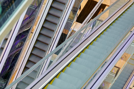 Crisscross escalators in shopping center photo