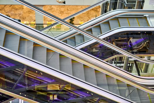 Crisscross escalators in shopping center photo