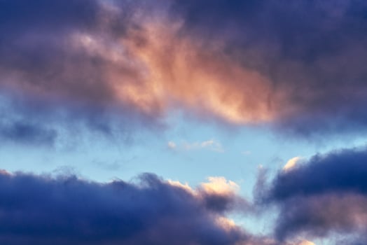 Fluffy cumulus purple and pink clouds, cloudscape photo