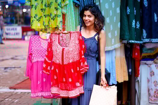Lady Walking In Blue Dress Holding Shopping Bags While Walking In Sarojini Market Delhi photo