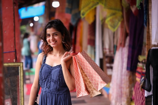 Beautiful Brunette Woman Holding Shopping Bags While Looking At Camera photo