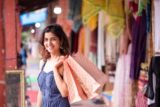 Blond Woman Holding Shopping Bags While Looking At Camera photo
