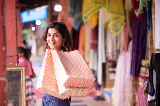 Hot Blonde Woman Looking Back While Holding Shopping Bags photo