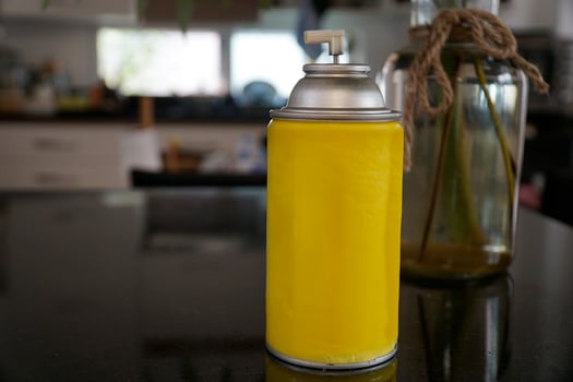 A yellow spray can on the table photo