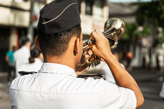 Military man of back playing a trumpet in the parade. photo