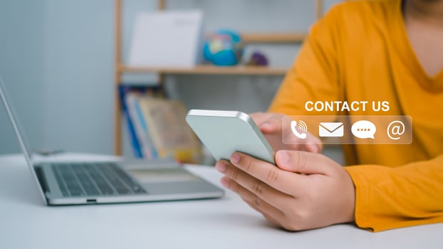 Website page, contact us or email marketing concept, customer support hotline, contact us. Businesswoman sitting and working on computer. Email, phone, address, chat message icon. photo